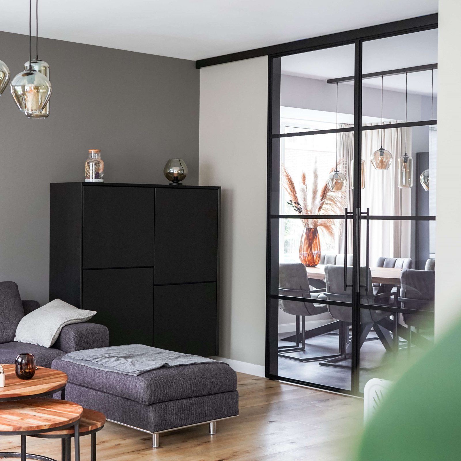 Schwarze Loft-Schiebetür mit Sprossen zwischen Wohnzimmer und Essbereich